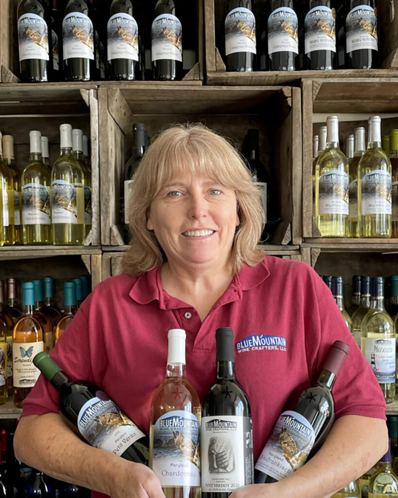 Cindy holds award-winning wines from the 32nd Annual Maryland Governor’s Cup Competition