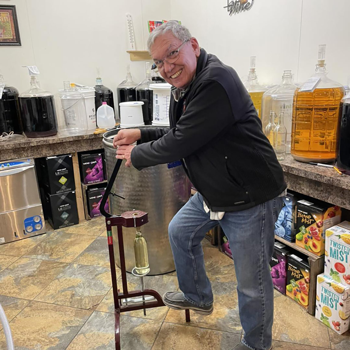 324310928_528199472599977_4806558697105338763_n Bill, our favorite volunteer, helping to bottle wine