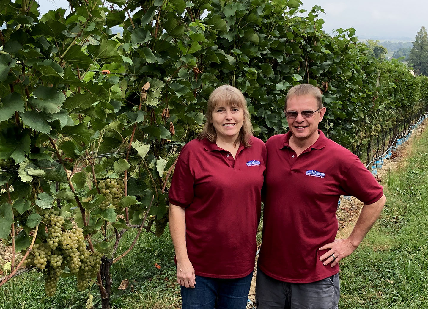 Cindy and Tim Rowe Cindy and Tim Rowe, owners, standing at the vineyard